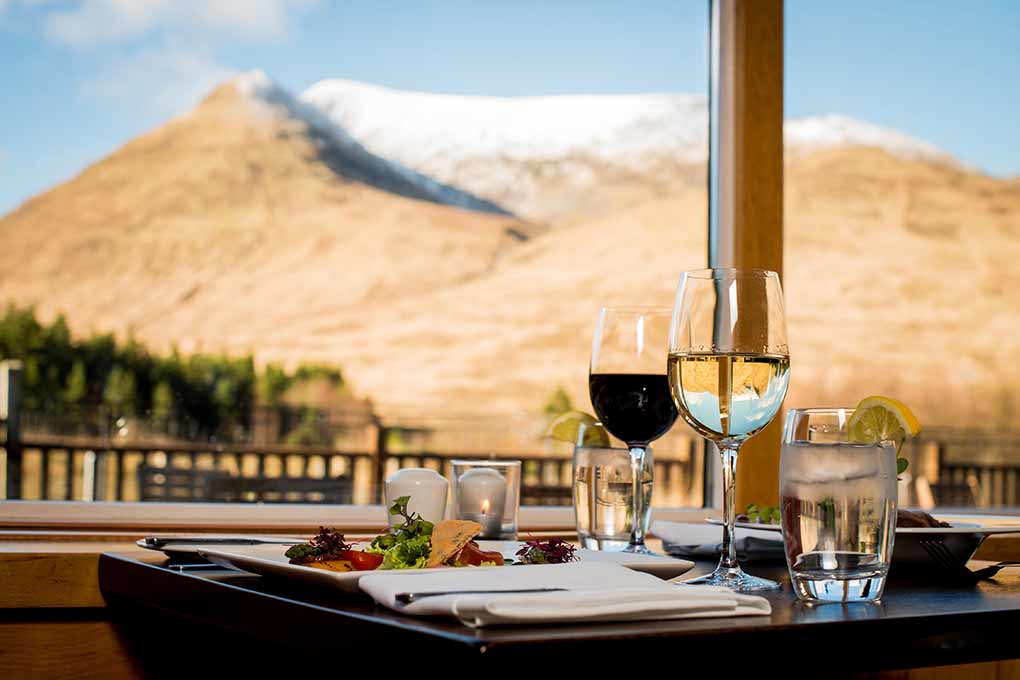 table with wine glasses and view in restaurant at Delphi