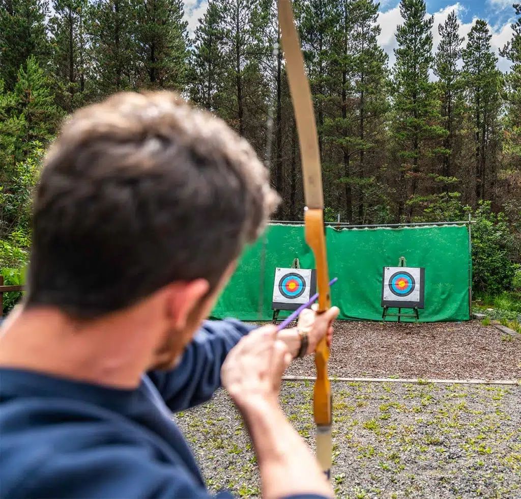 man practicing archery - stag party in galway