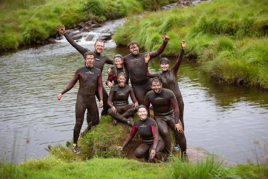 possing muddy close to a river at Delphi groups activities