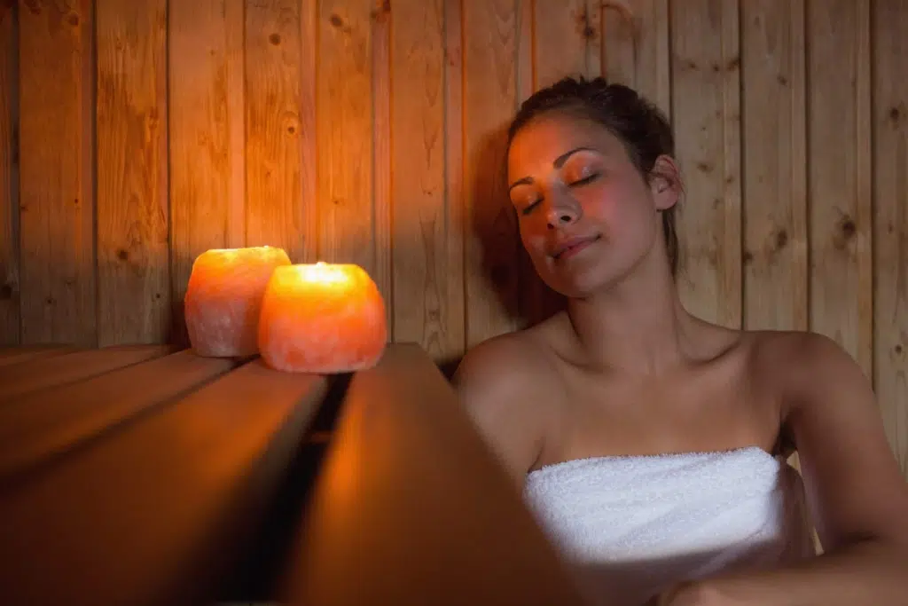 woman at Sauna with candles in Spa Day experience