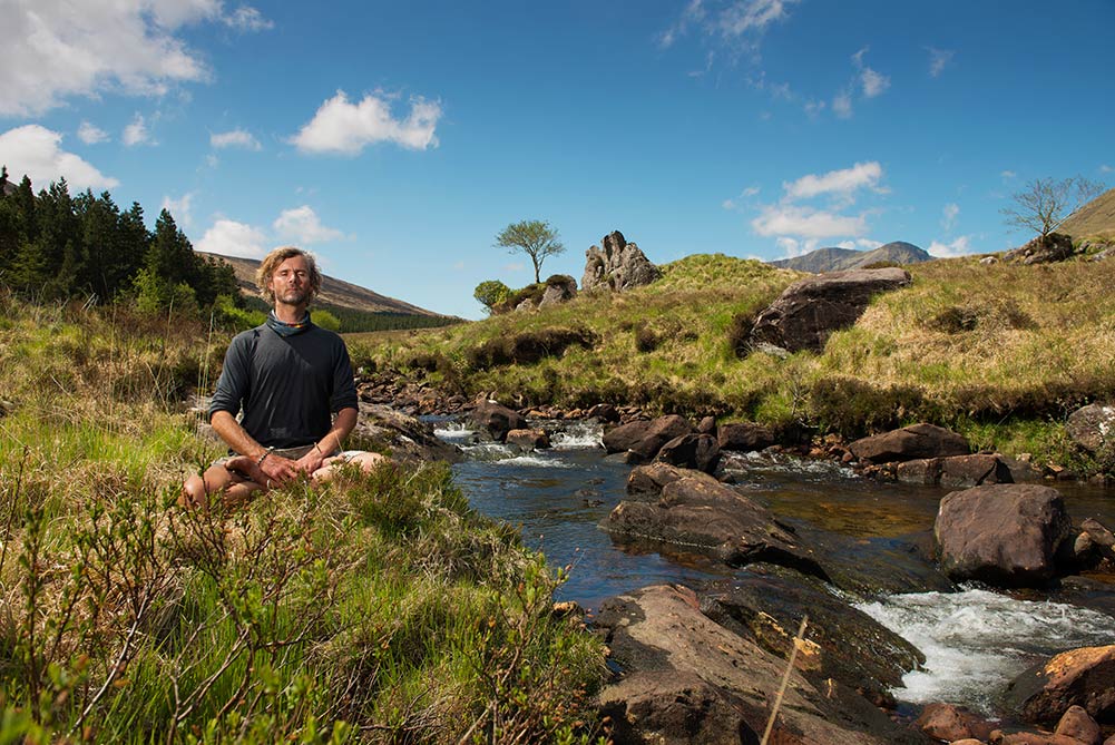 man meditating in yoga retreat